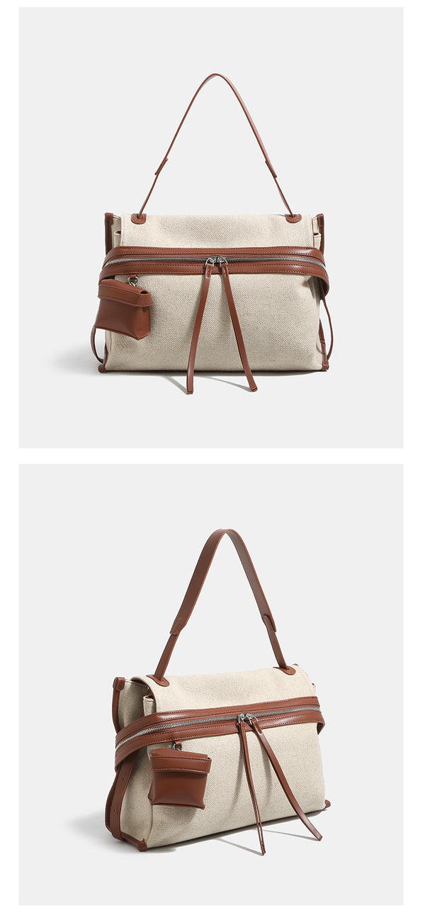 Off-white woven cotton-linen shoulder bag with brown leather-look trim, dual zip closure, long zipper pulls, front exterior