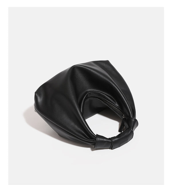 Slouchy leather-look hobo bag with knotted loop handle and top zipper closure, detail view 11