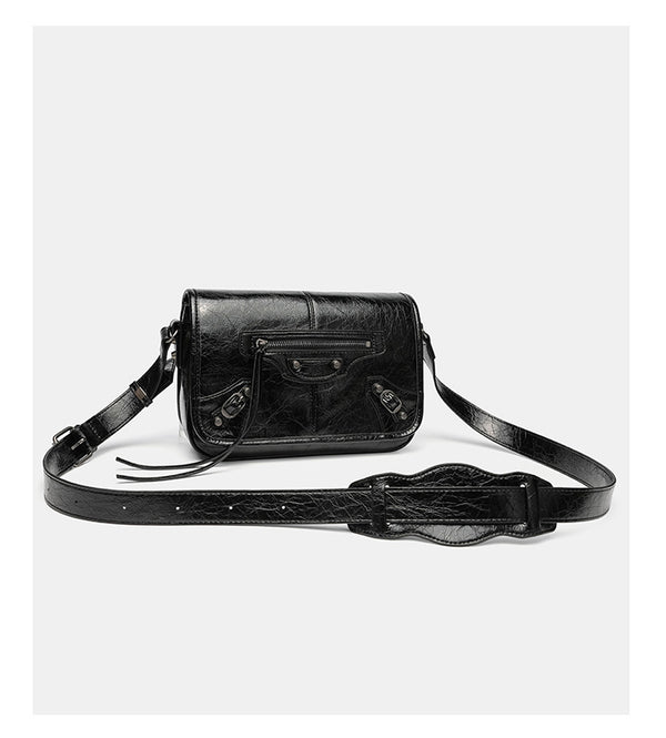 Small structured rectangular crossbody bag with crinkle leather-look finish, front zip pocket, gunmetal stud hardware, and