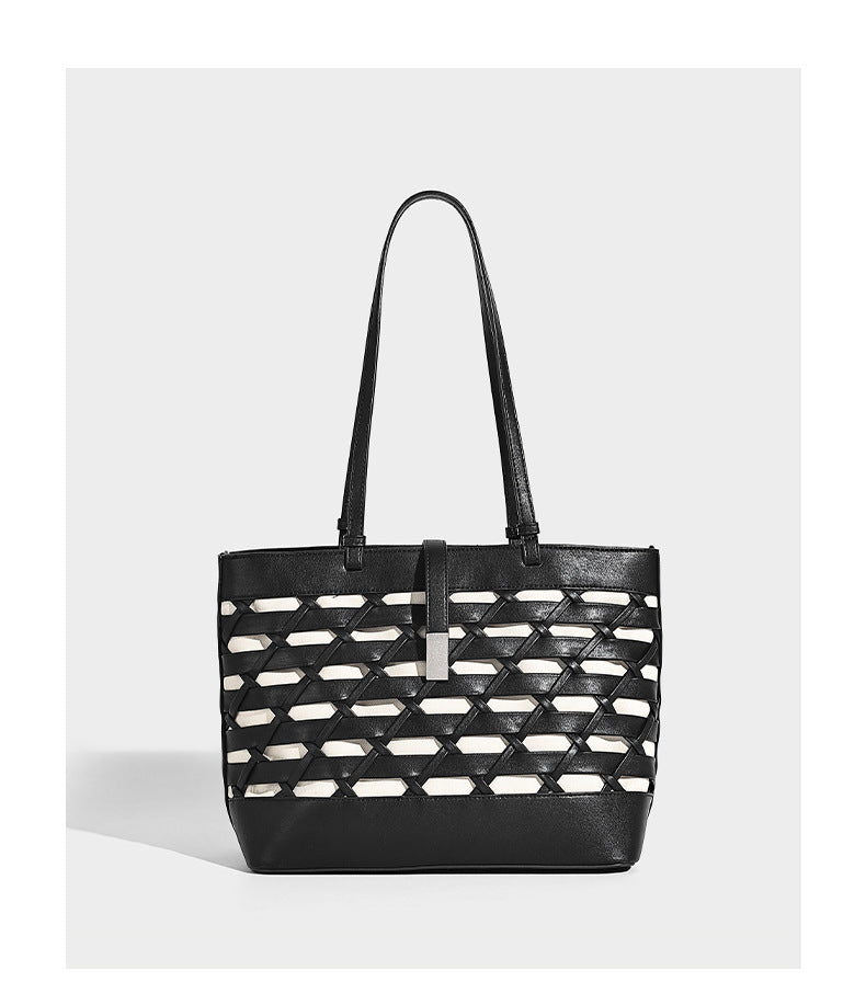 Structured woven lattice cutout tote bag with smooth leather-look trim, dual shoulder straps, and silver-tone hardware