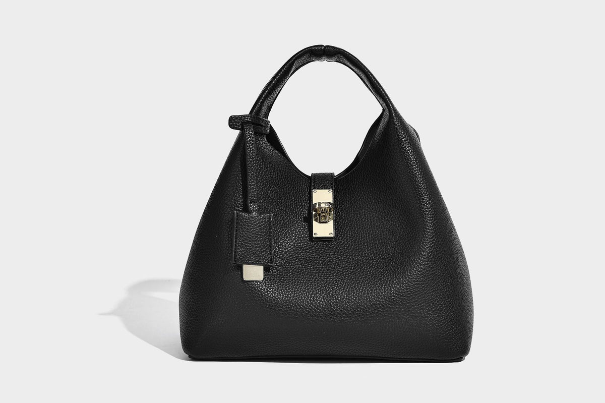 Structured pebbled-texture bucket bag with arched top handles, gold-tone turn-lock closure, and detachable shoulder strap