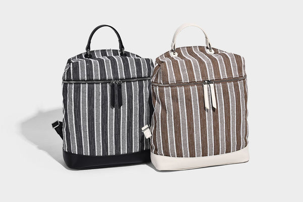 Small structured striped fabric backpack handbag with cream leather-look trim, top handle, and silver-tone hardware, detail