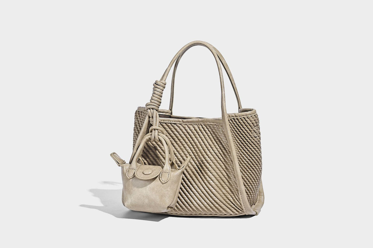 Large structured woven rope-texture tote bag with smooth leather-look trim, knotted dual top handles, detachable mini front