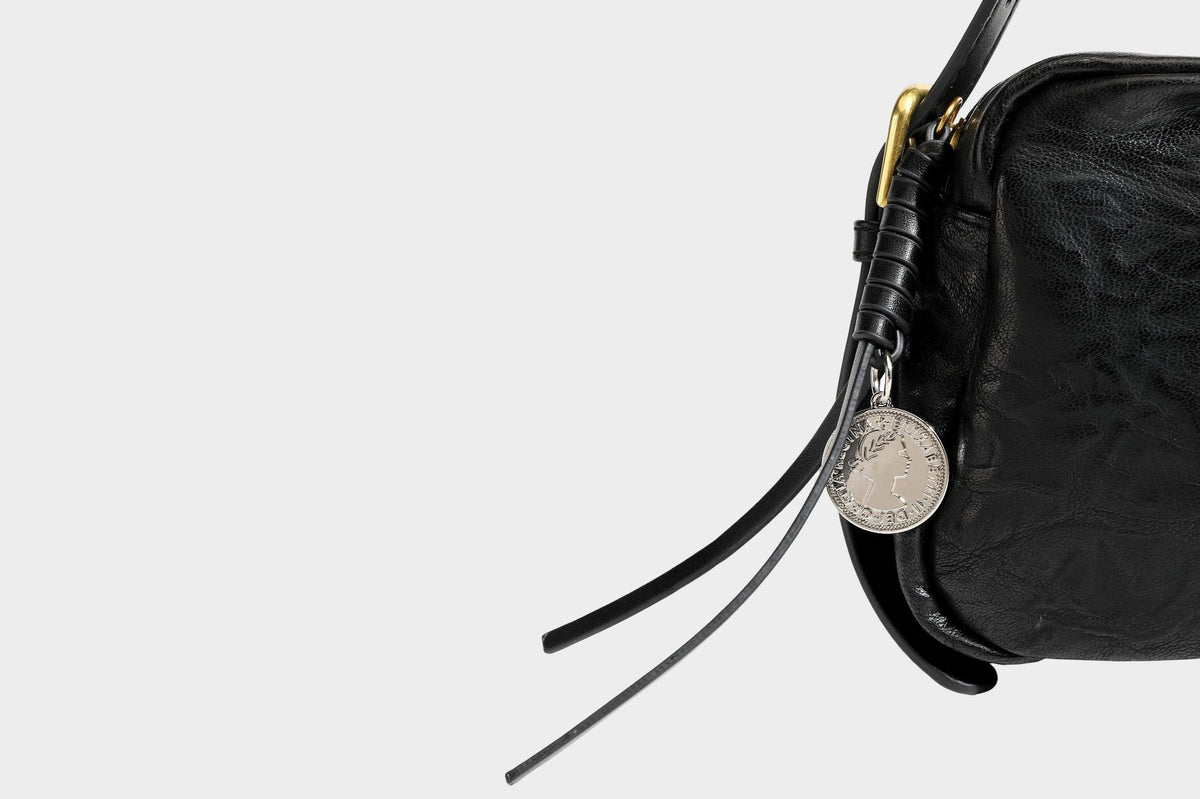 Compact black crinkled leather-look baguette shoulder bag with gold-tone arch hardware and adjustable strap, detail view 30