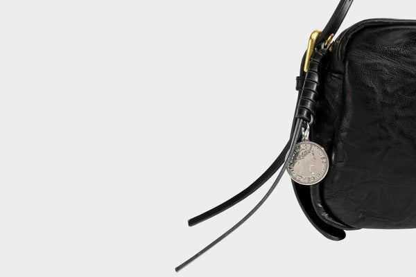 Compact black crinkled leather-look baguette shoulder bag with gold-tone arch hardware and adjustable strap, detail view 30
