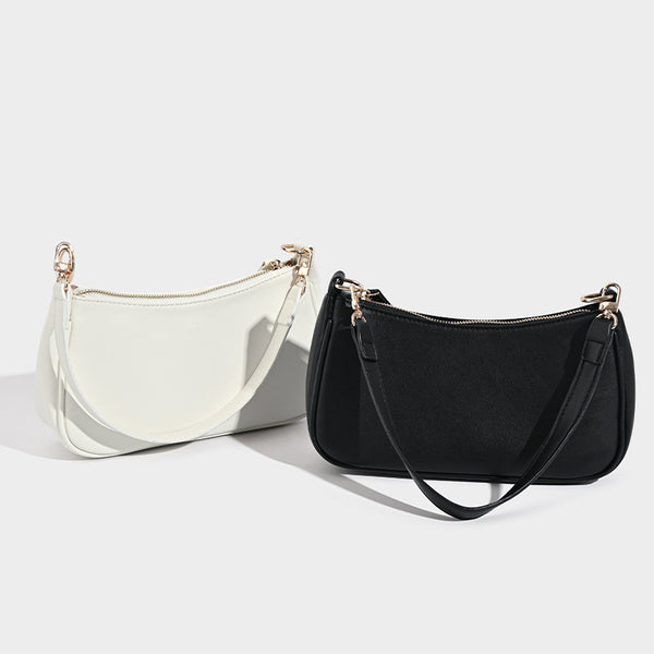 Kompakte Baguette-Schultertasche mit bogenförmiger Silhouette, strukturierter Oberfläche in Lederoptik und goldfarbenen Metalldetails, Detailansicht 2