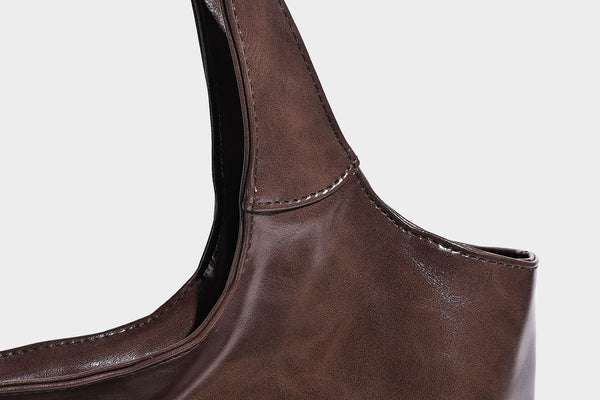 Glossy oil-wax leather-look open-top tote shoulder bag with embossed circular logo and long double straps, detail view 30