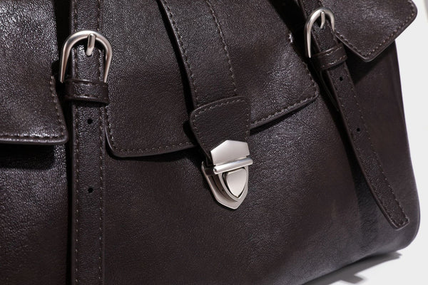 Large structured vintage-style tote bag with flap-front turn-lock closure, twin buckle straps, and double shoulder handles