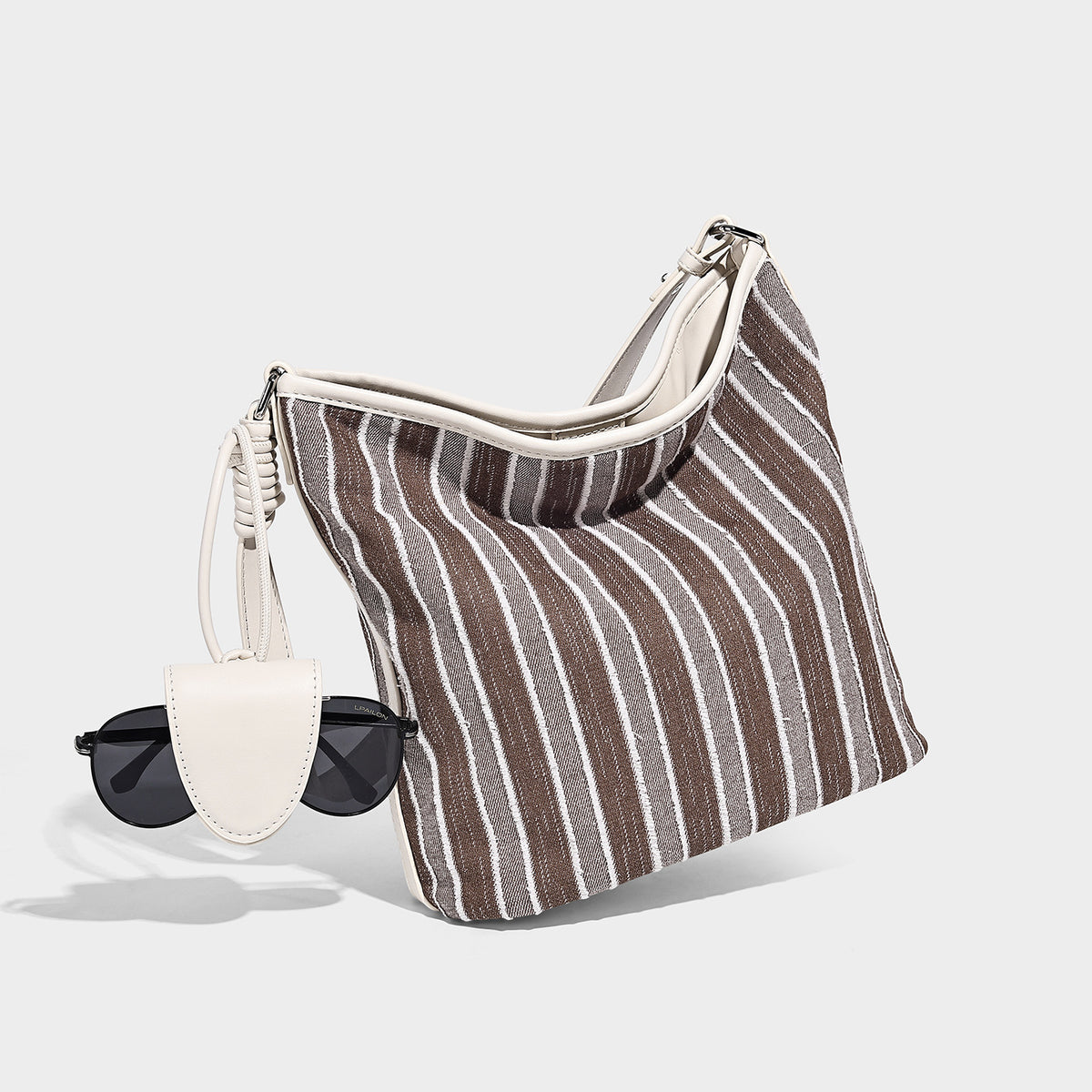 Large striped canvas hobo shoulder bag with cream trim and silver-tone hardware, detail view 3