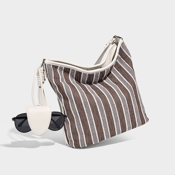 Large striped canvas hobo shoulder bag with cream trim and silver-tone hardware, detail view 3