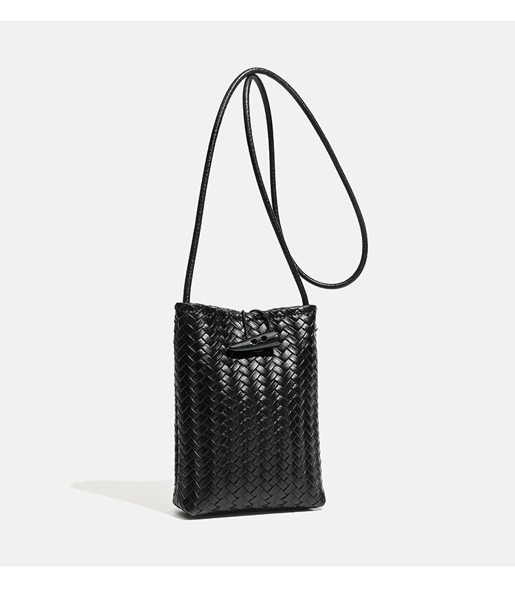 Compact woven leather-look bucket crossbody pouch with toggle closure and long fixed strap, detail view 12