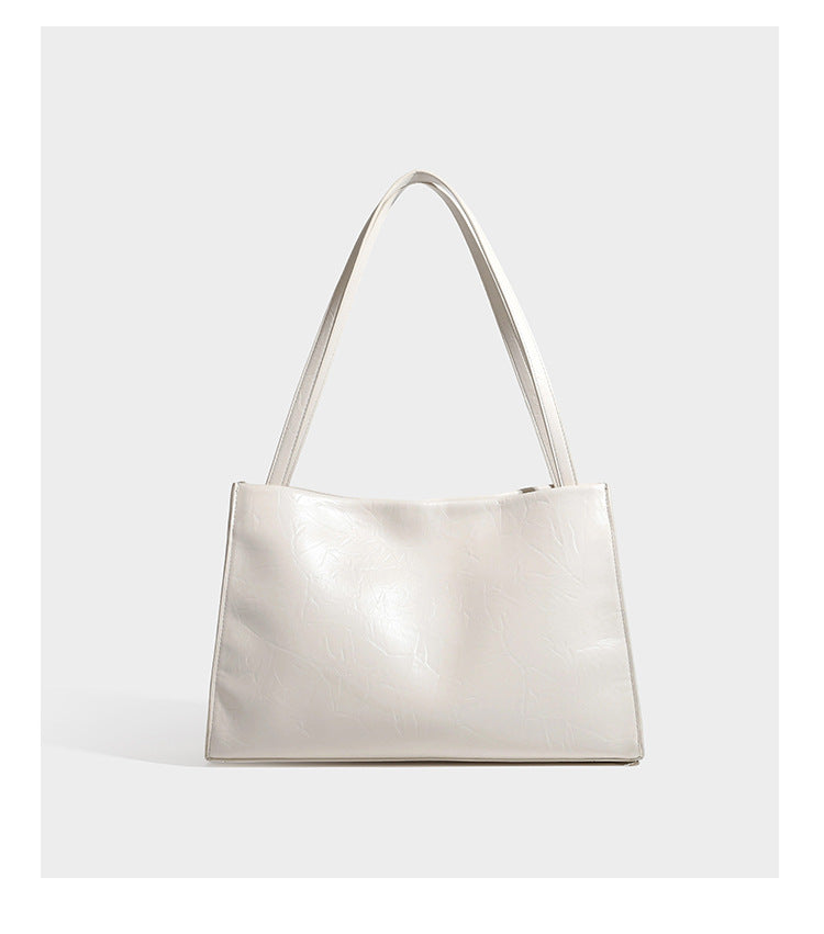 Strukturierte, rechteckige Tote-Schultertasche mit glänzender, geknautschter Lederoptik, langen Doppelriemen und goldfarbenem Emblem