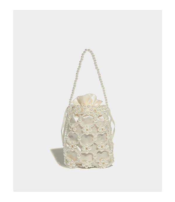 Small pearl-beaded lattice drawstring bucket bag with beaded shoulder strap and ribbon closure, detail view 12