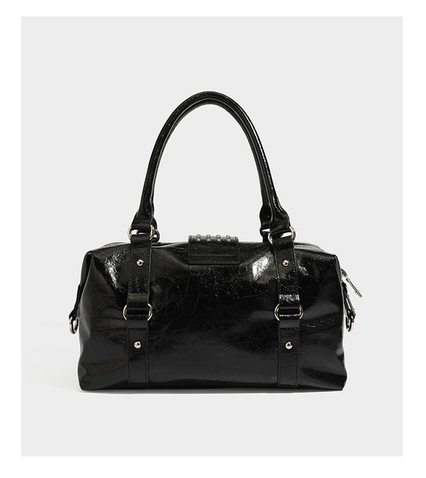 Glossy crinkled barrel handbag with silver stud buckle strap and detachable shoulder strap, detail view 10
