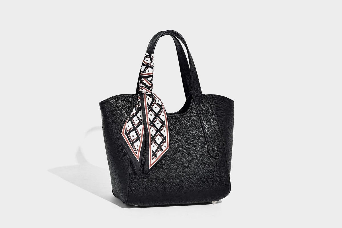 Structured pebbled leather-look tote bag with detachable scarf tie, dual top handles, and adjustable crossbody strap, detail