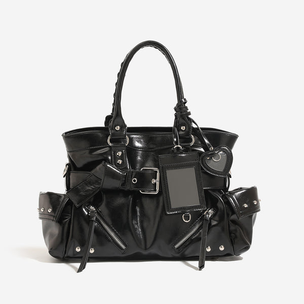 Black glossy leather-look structured tote bag with silver studs, buckle strap, exterior zip pockets, braided top handles