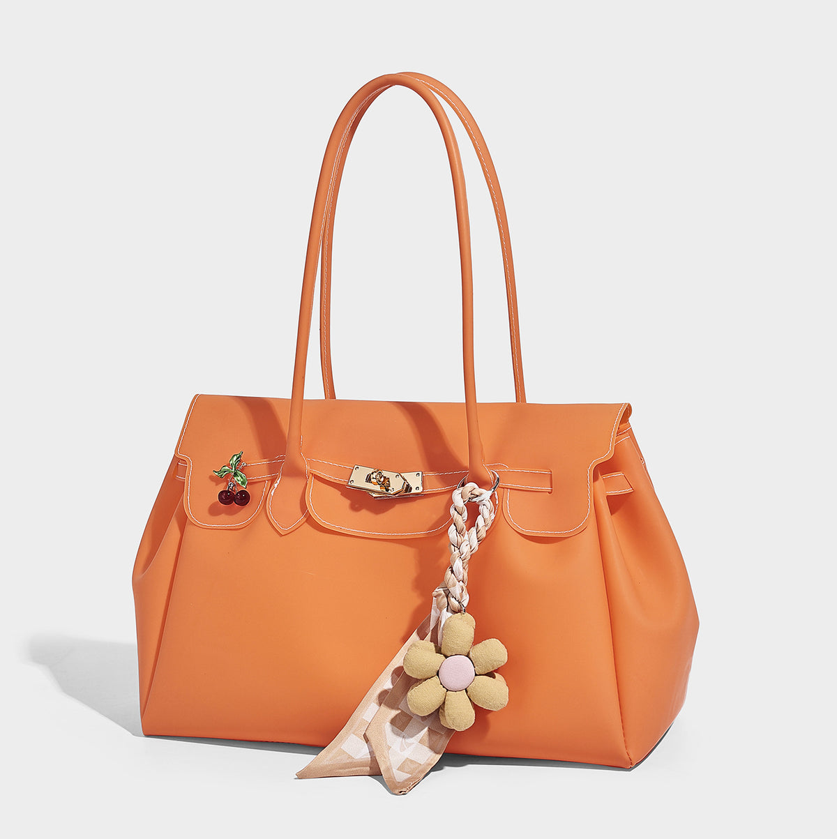 Structured matte jelly tote bag with gold-tone turn-lock flap closure, double shoulder handles, side gussets, and decorative