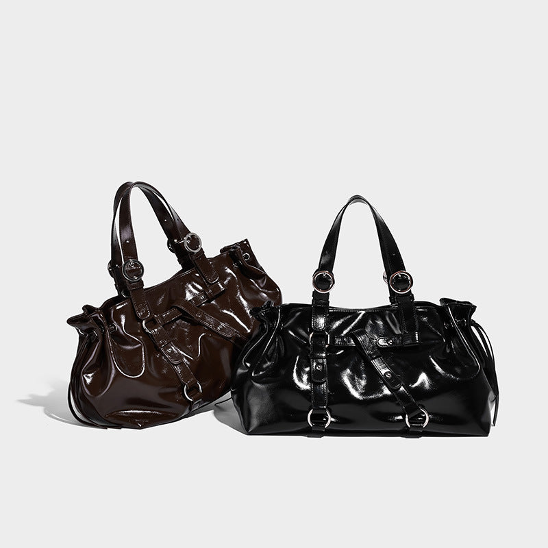 Glossy patent-look slouchy tote bag with ruched drawstring sides, dual top handles, silver ring hardware, and detachable