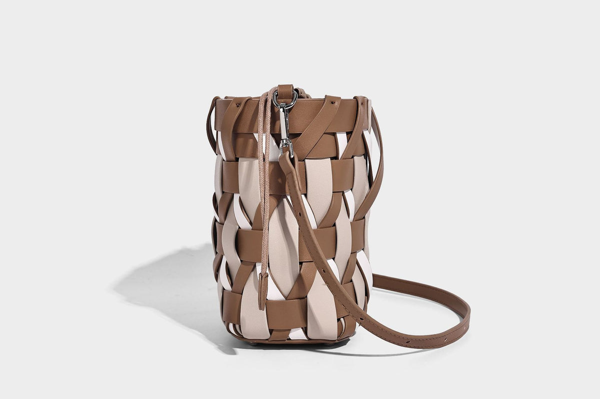 Small woven lattice bucket bag in tan and cream leather-look strips with drawstring top and detachable crossbody strap
