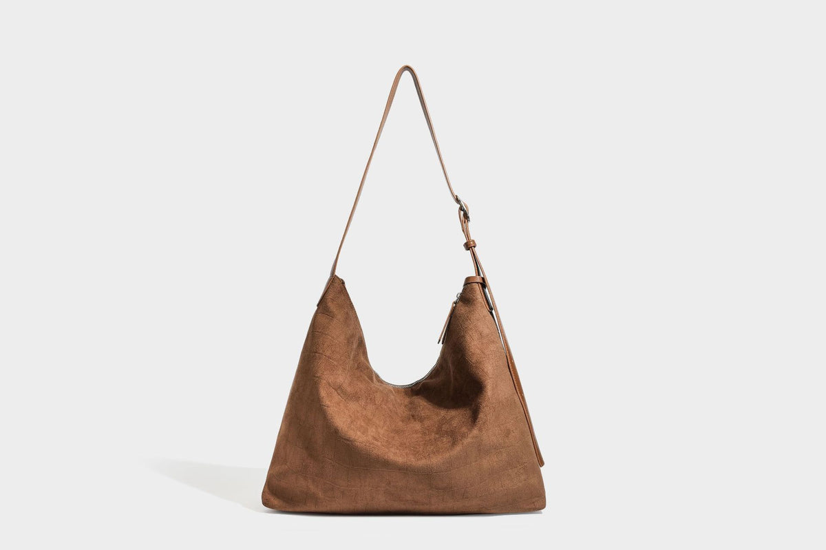Slouchy hobo shoulder bag in matte croc-embossed leather-look finish with top zip closure and long adjustable strap, detail