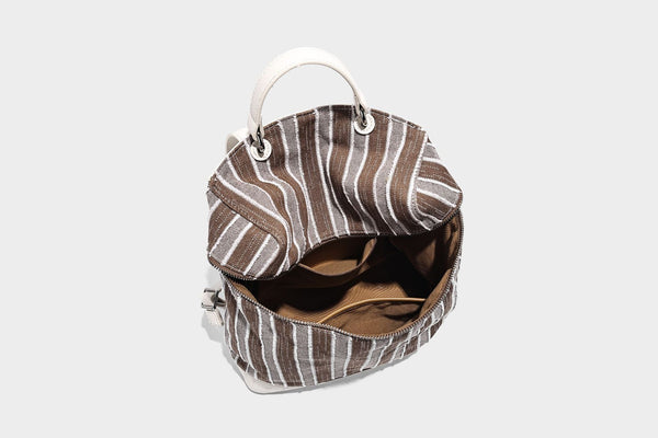 Small structured striped fabric backpack handbag with cream leather-look trim, top handle, and silver-tone hardware, detail