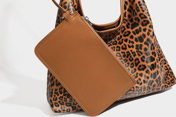 Glossy leopard-print slouchy shoulder bag with long strap and detachable tan zip pouch, detail view 20