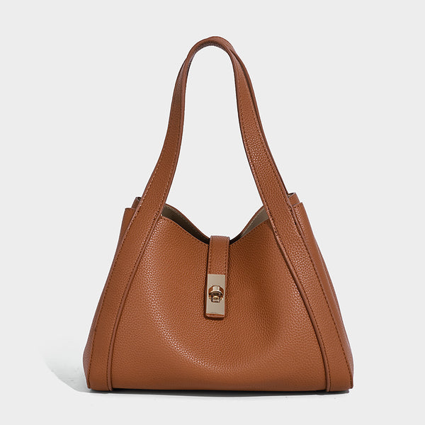 Structured trapezoid tote bag in taupe pebbled leather-look finish with gold-tone turn-lock hardware, dual top handles, and