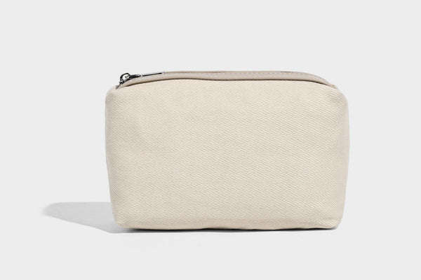 Small pebbled half-moon shoulder bag with dual top handles, detachable crossbody strap, and silver-tone hardware, detail view