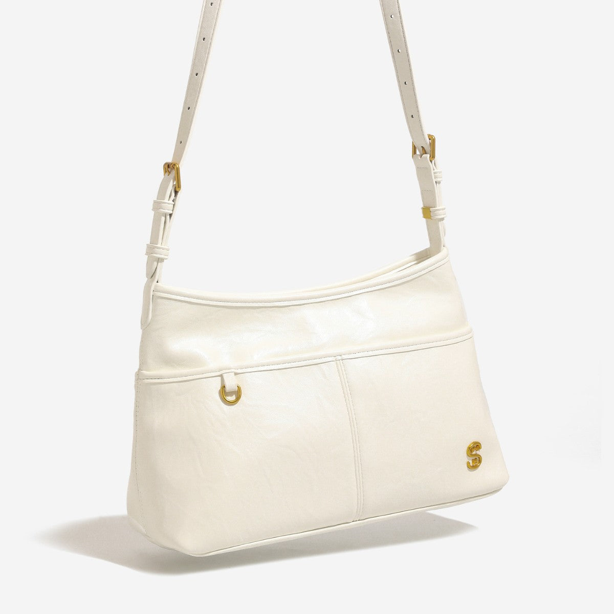 Relaxed leather-look shoulder tote bag in cream white with front exterior pocket, gold-tone ring hardware, and adjustable