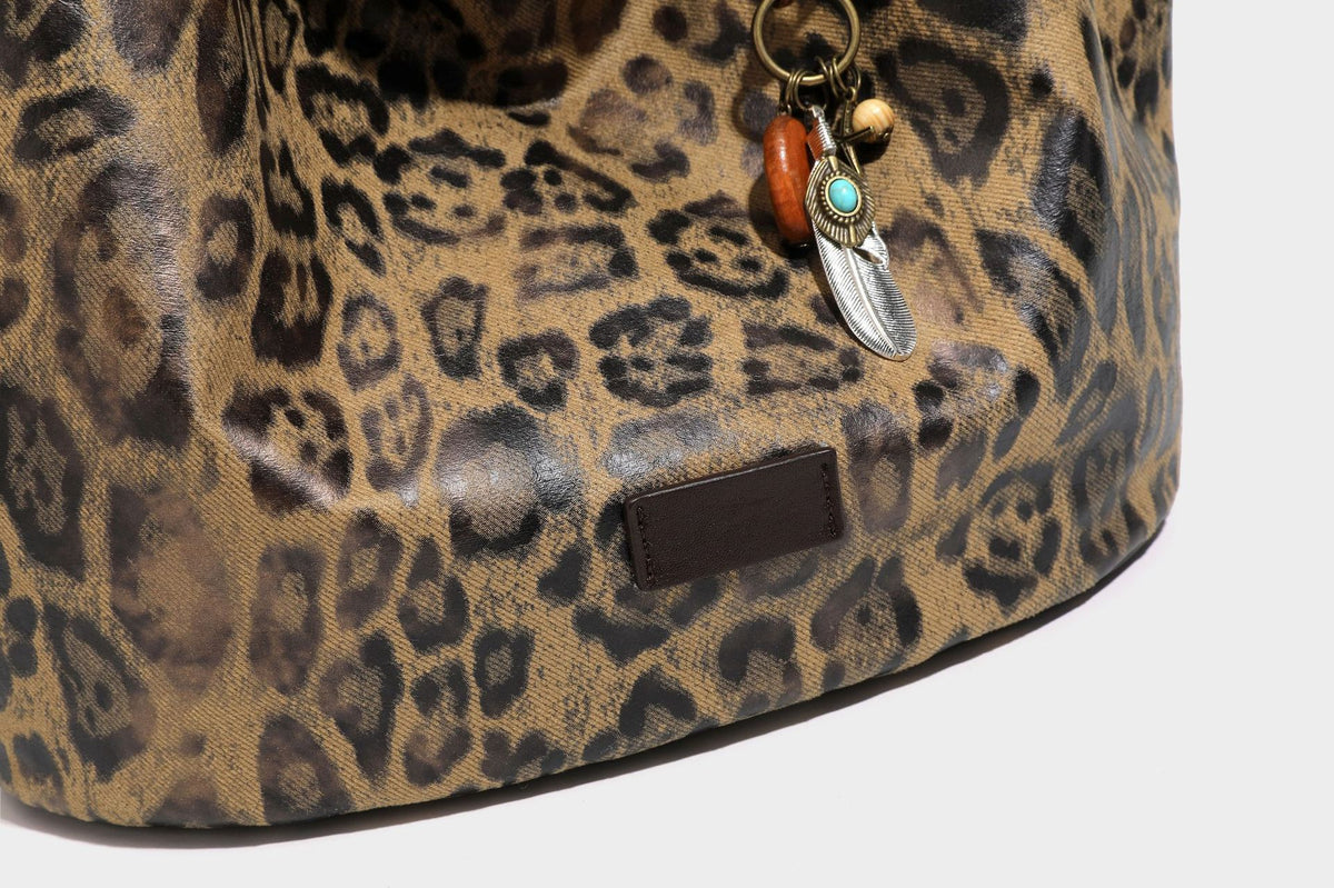 Large slouchy leopard-print shoulder tote bag with glossy tan-and-brown finish, dark brown leather-look trim, single