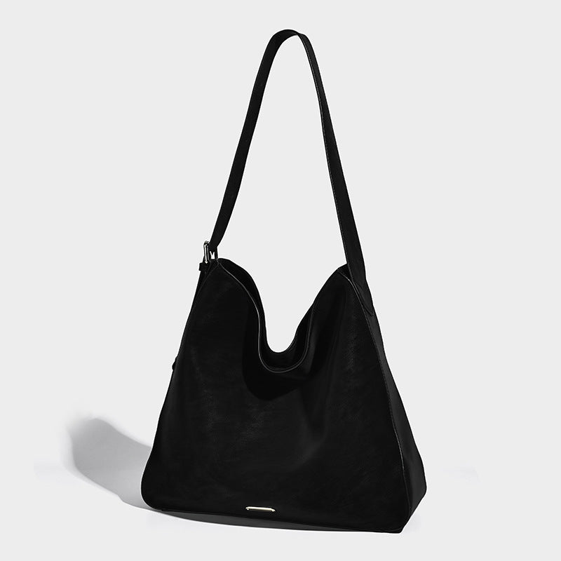 Large slouchy hobo shoulder bag in matte leather-look finish with adjustable strap and gold-tone bar hardware, detail view 6