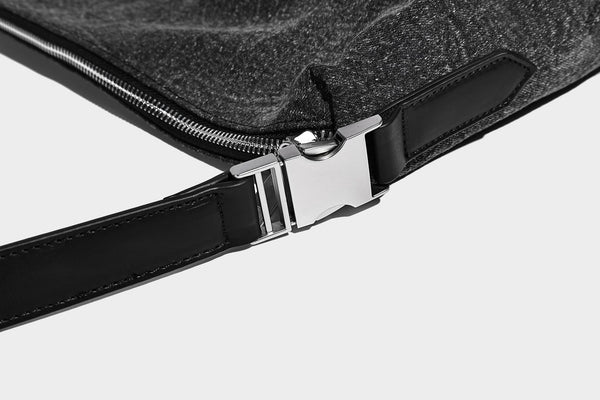 Charcoal denim-textured slouchy hobo bag with zip-top closure, silver-tone hardware, and adjustable leather-look crossbody