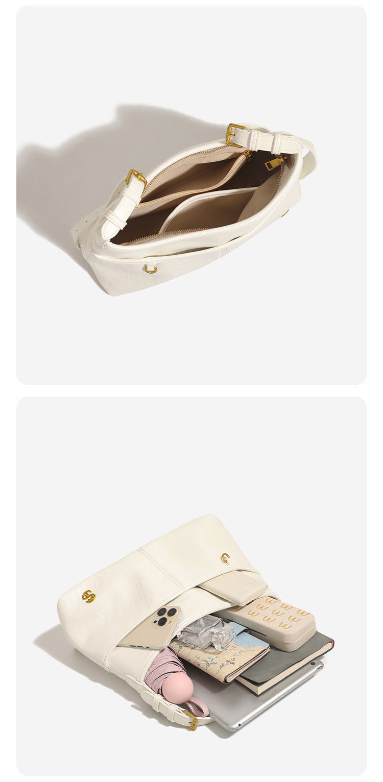 Relaxed leather-look shoulder tote bag in cream white with front exterior pocket, gold-tone ring hardware, and adjustable