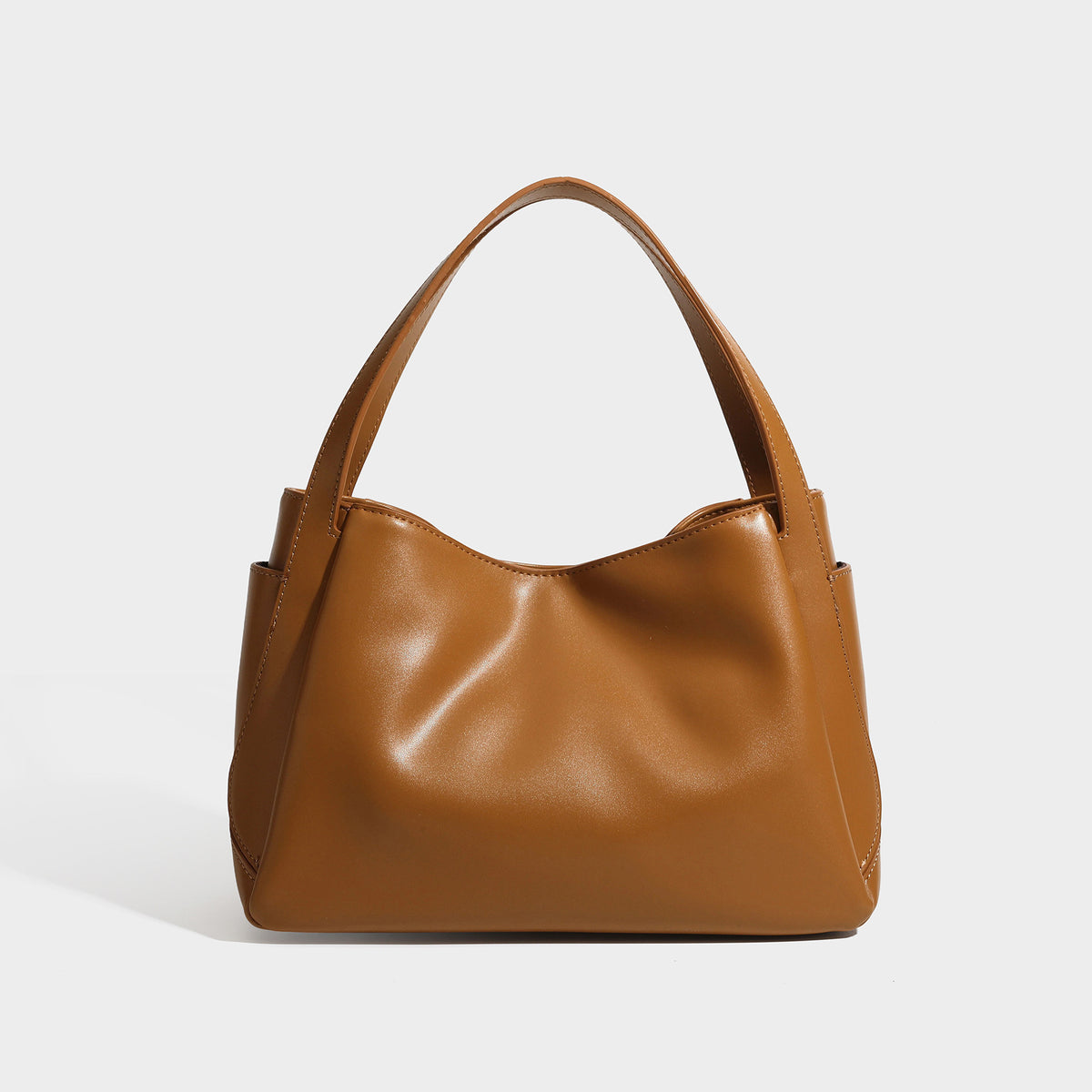 Structured glossy leather-look tote shoulder bag with dual top handles, detachable crossbody strap, side pockets, and, detail