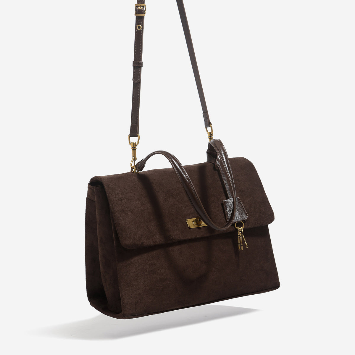 Large structured dark brown suede-finish satchel bag with gold-tone turn-lock closure, key charm accent, and detachable