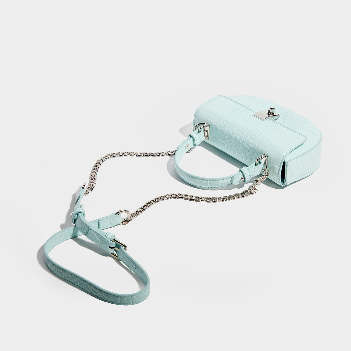 Glossy croc-embossed mini saddle bag with silver-tone turn-lock clasp and short top handle, detail view 4