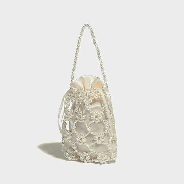 Small pearl-beaded lattice drawstring bucket bag with beaded shoulder strap and ribbon closure, front view