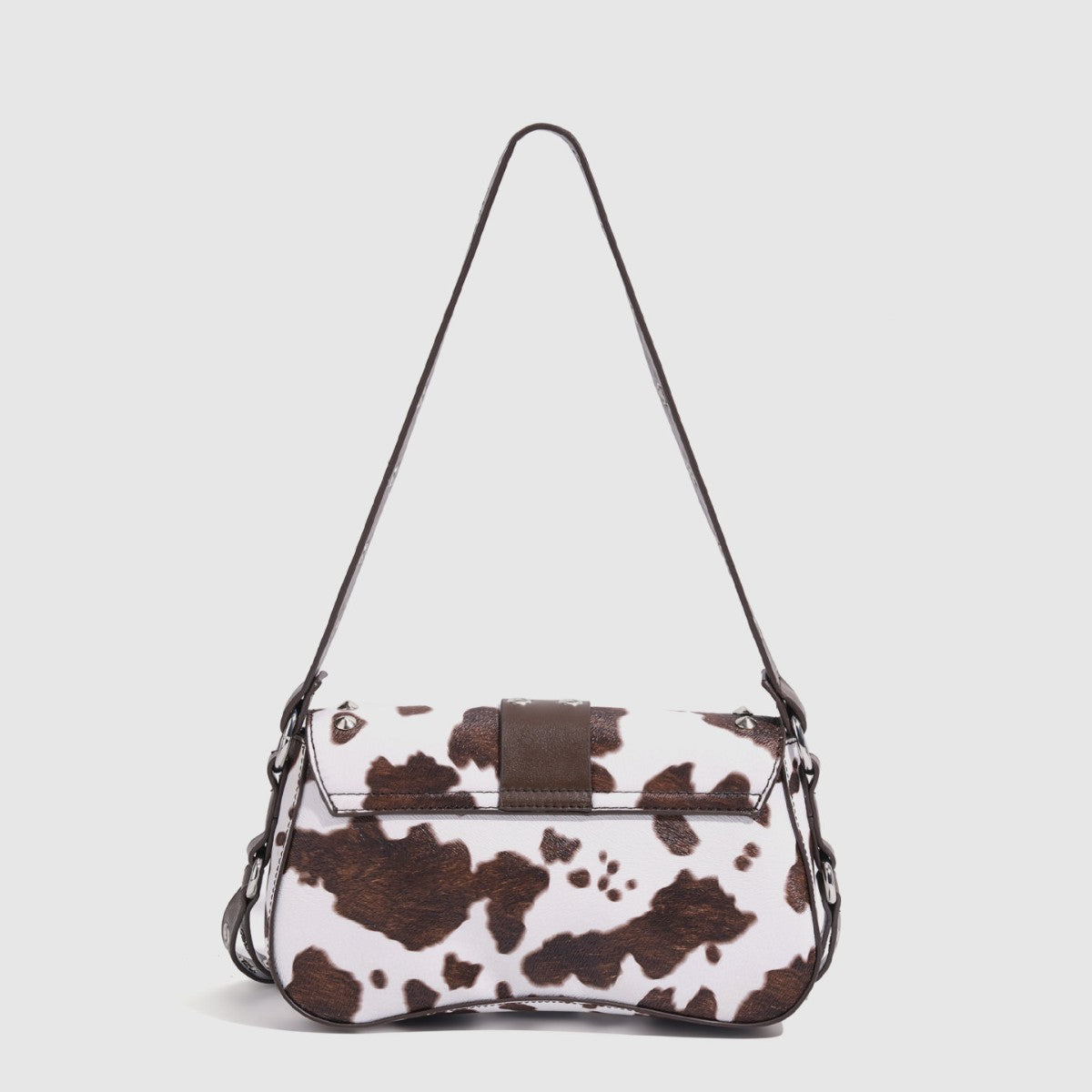 Mini square cow-print leather-look shoulder bag with metal stud hardware and dual carry straps, detail view 4