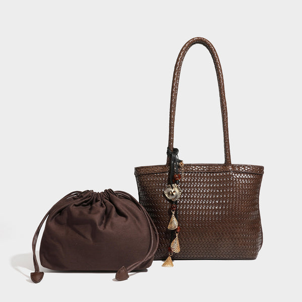 Structured woven leather-look tote bag in dark brown with long shoulder straps, side drawstring ties, and gold filigree