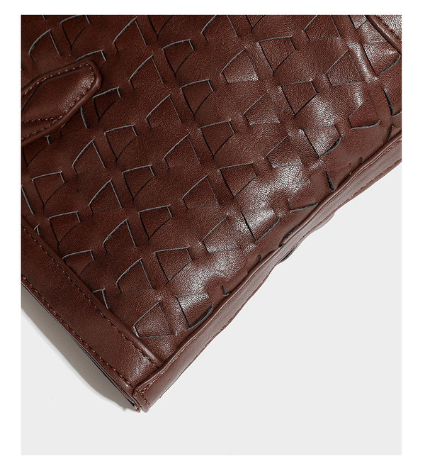Large leather-look tote bag with geometric woven emboss, double shoulder straps, and round woven cord charm in brown, detail