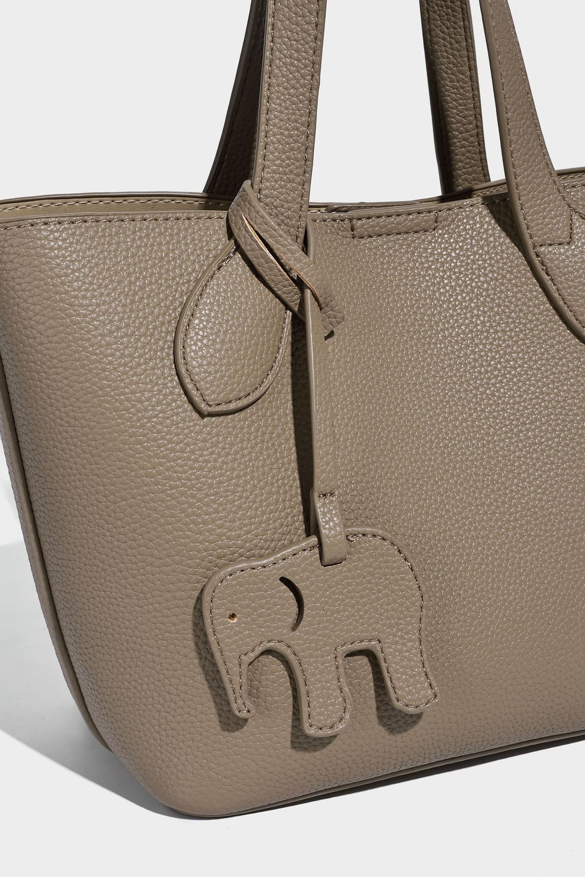 Compact pebbled bucket tote bag with elephant charm, twin top handles, and detachable crossbody strap, detail view 15