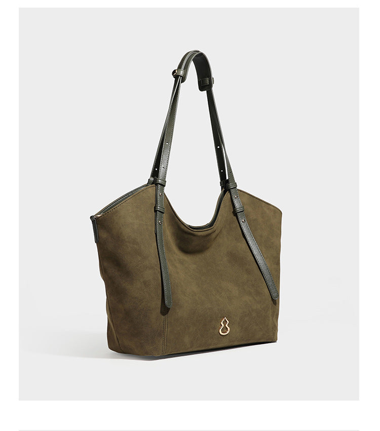 Oversized suede-finish tote shoulder bag in caramel brown with slim leather-look straps and gold-tone logo hardware, detail