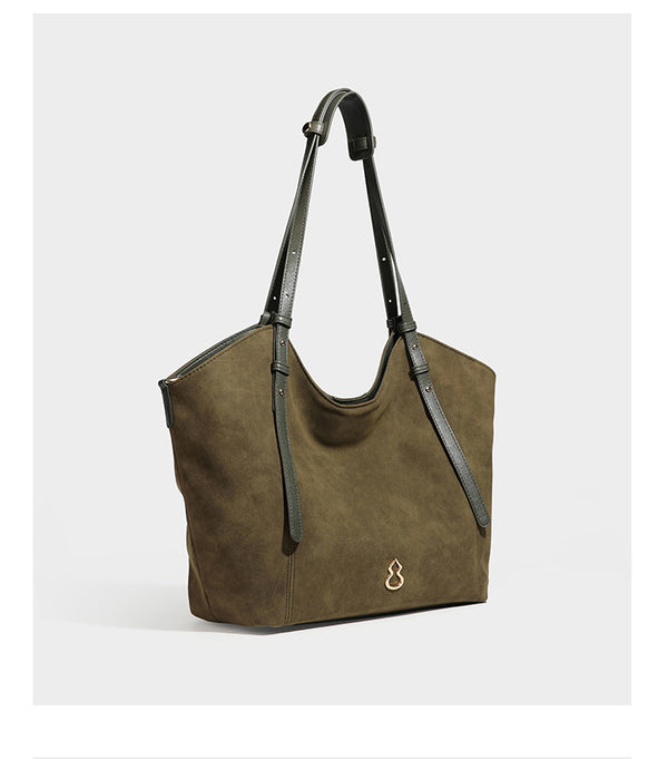 Oversized suede-finish tote shoulder bag in caramel brown with slim leather-look straps and gold-tone logo hardware, detail