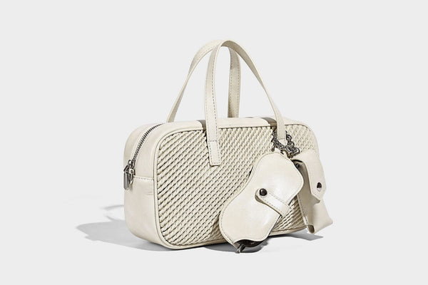 Structured woven-texture front top-handle handbag with zip closure, dual handles, detachable shoulder strap, and matching