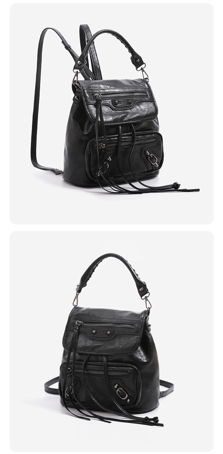 Mini flap backpack handbag with silver stud hardware, front zip pockets, and drawstring tassels, detail view 11
