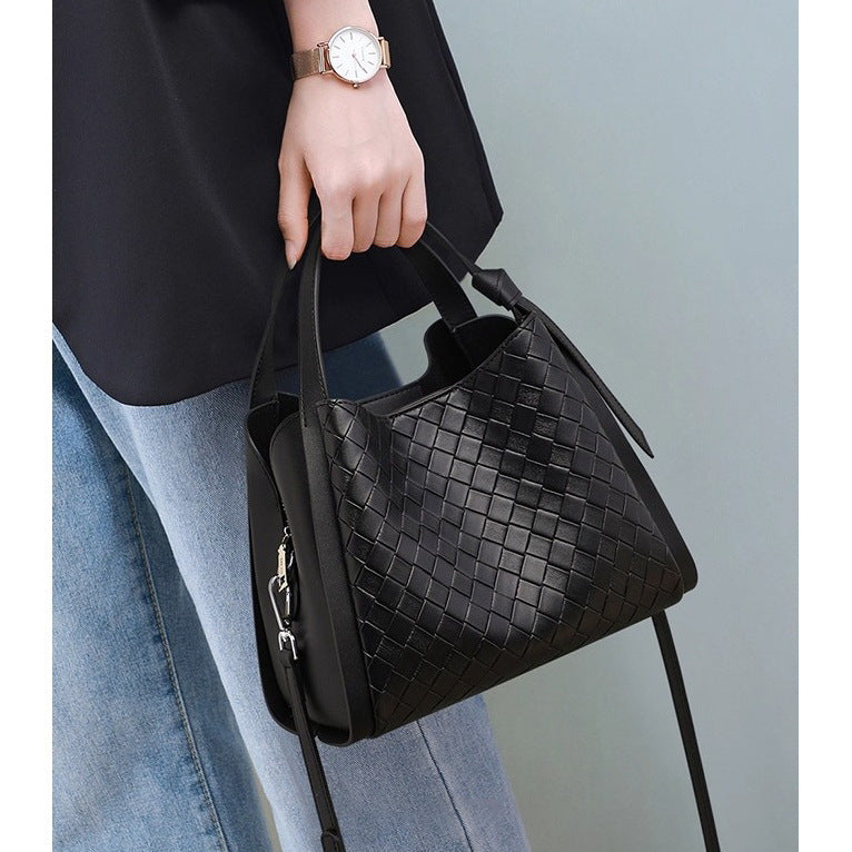 Black woven leather-look bucket tote bag with dual top handles and detachable shoulder strap, silver-tone hardware and zip