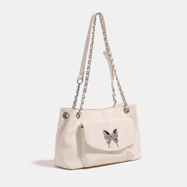 Soft rectangular glossy leather-look shoulder bag with silver chain strap, butterfly ornament on front flap pocket, and