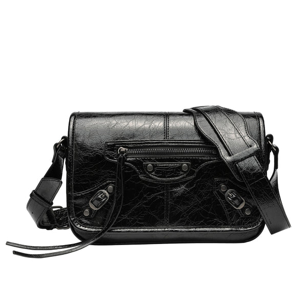 Small structured rectangular crossbody bag with crinkle leather-look finish, front zip pocket, gunmetal stud hardware, and