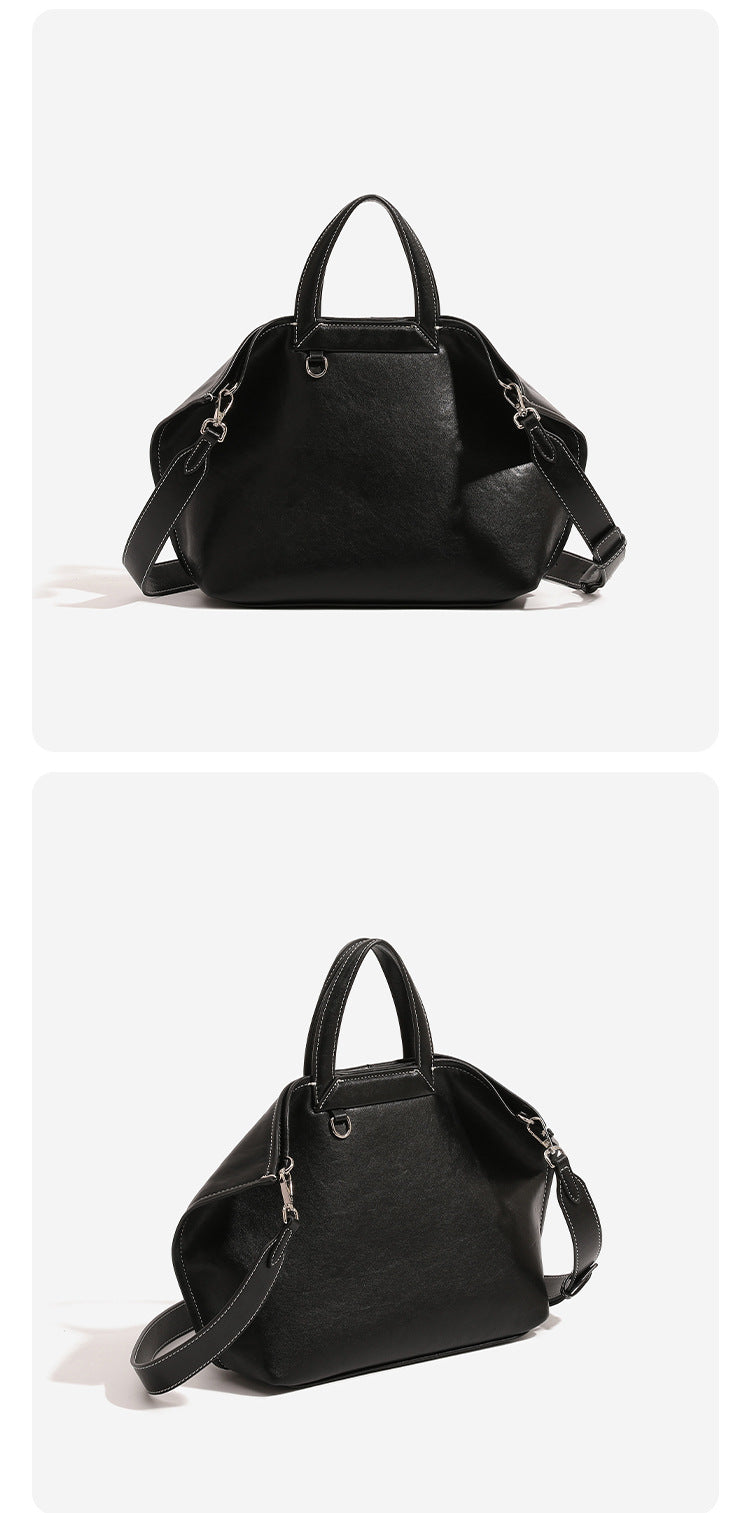 Structured cognac brown leather-look tote bag with fold-ear side panels, top handles, gold-tone hardware, and detachable