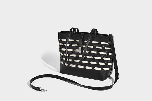 Structured woven lattice cutout tote bag with smooth leather-look trim, dual shoulder straps, and silver-tone hardware